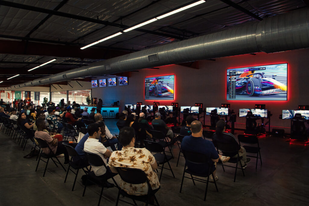 Formula 1 watch party in the event space of The Asylum. Racing simulators are under the screens